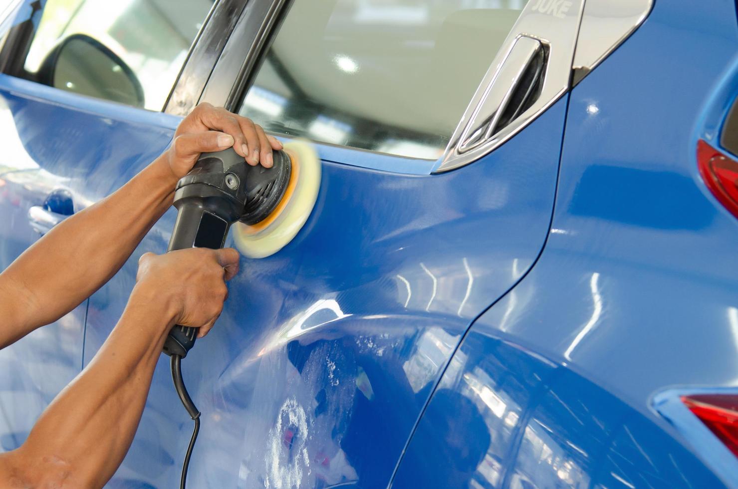 Polishing a blue car photo