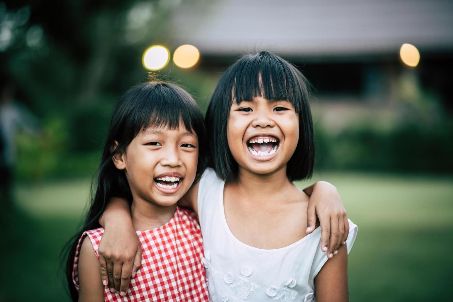 Two little girls having fun playing in the park photo