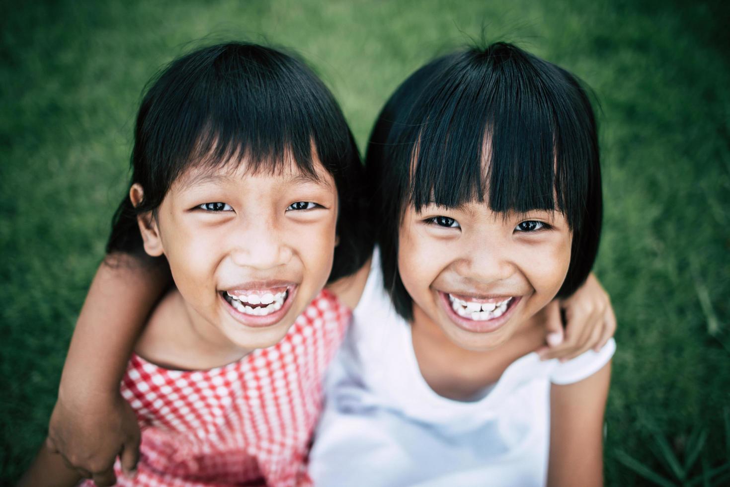 Two little girls having fun playing in the park photo