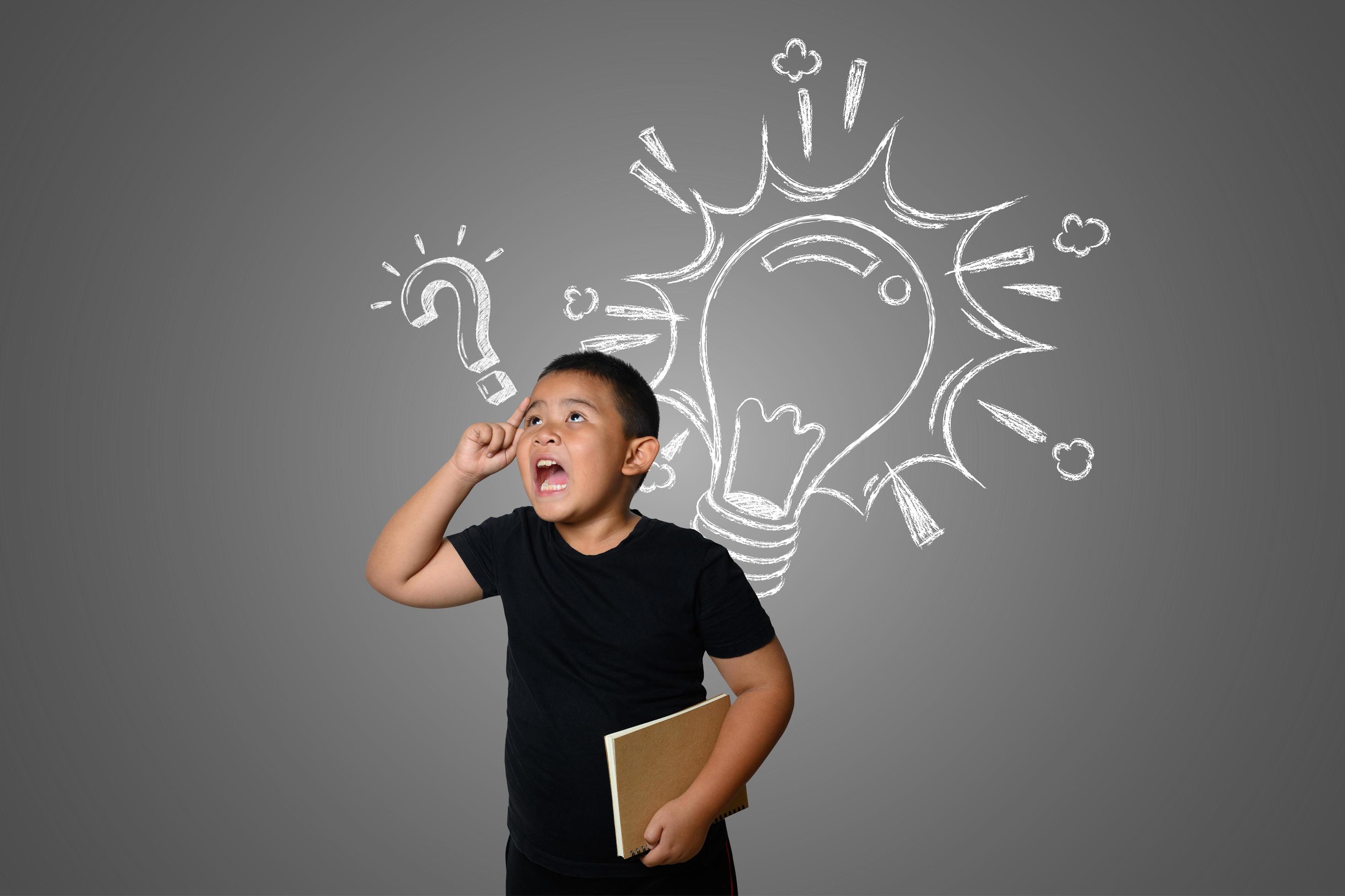 Confused young boy on neutral chalkboard background 1925566 Stock Photo