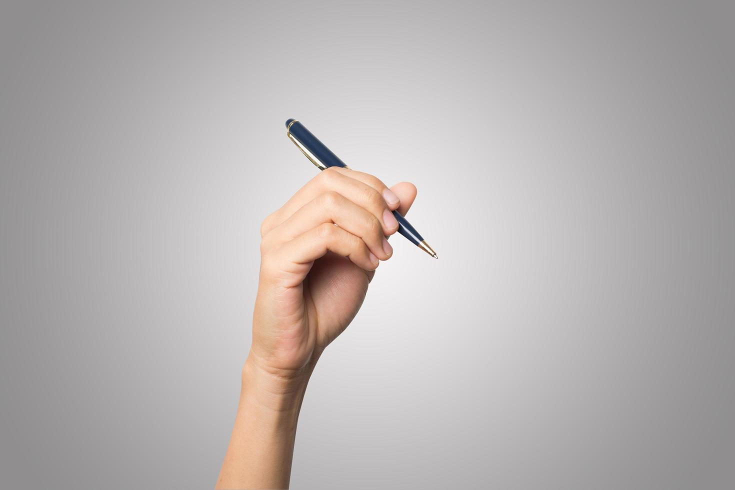 Woman's hand holding a pen isolated on white background photo