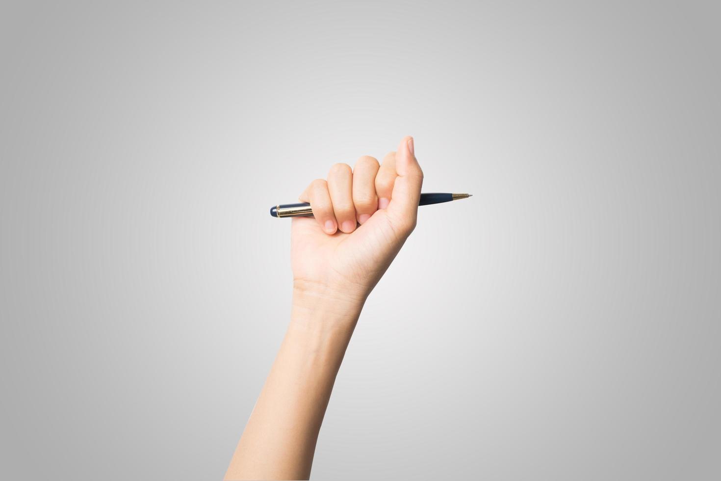 Woman's hand holding a pen isolated on white background photo