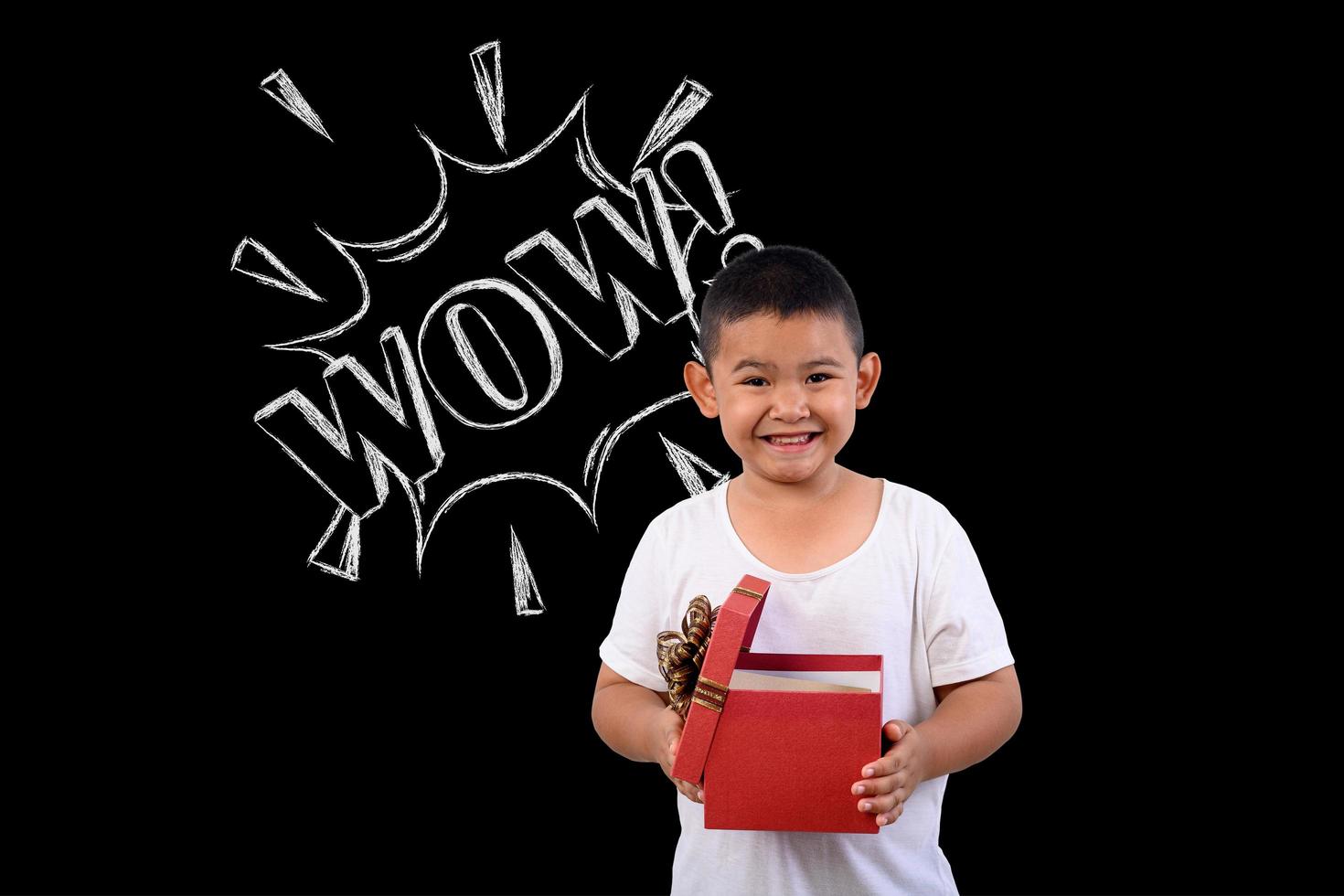 Young boy stands against a drawing on a blackboard photo