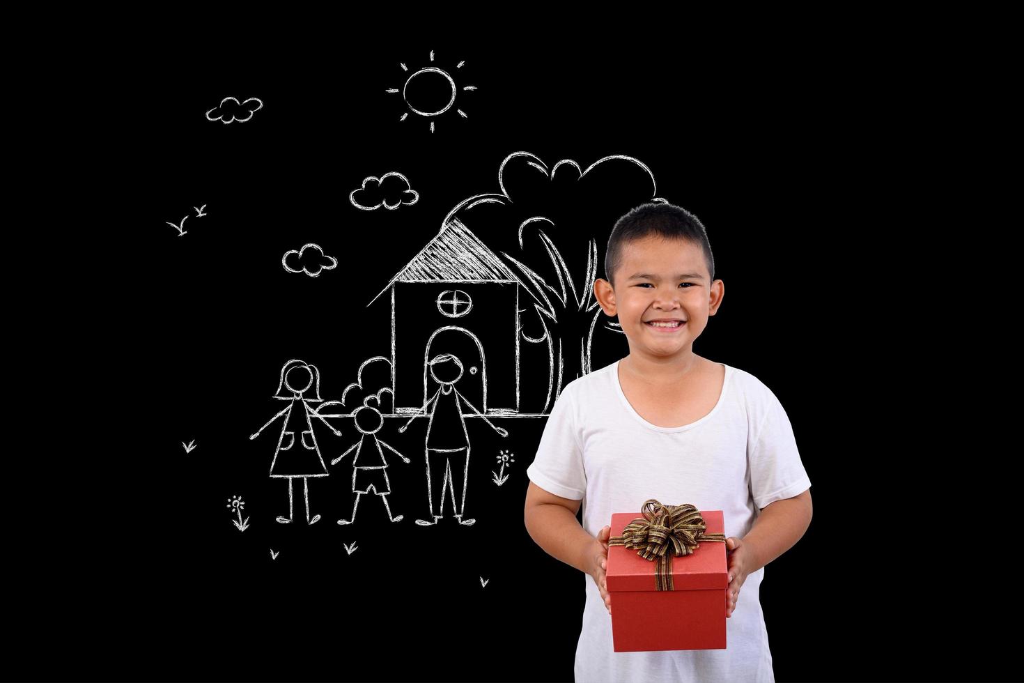 Young boy stands against a drawing on a blackboard photo