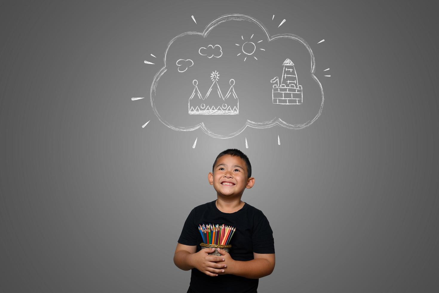 A boy with pencils drawing a dream background photo