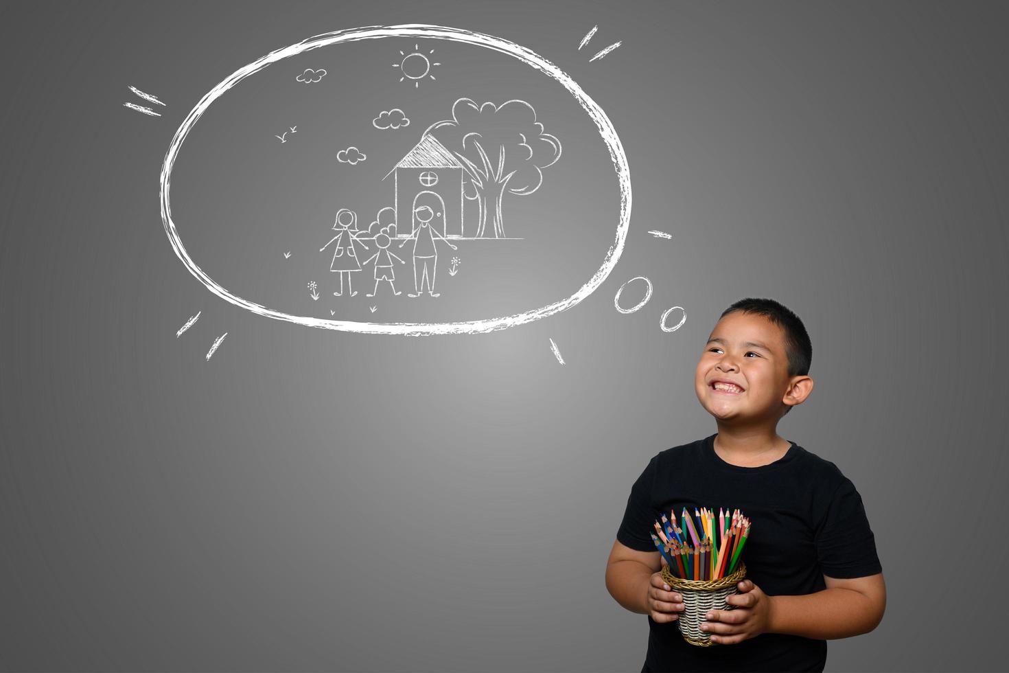 A boy with pencils drawing a dream background photo