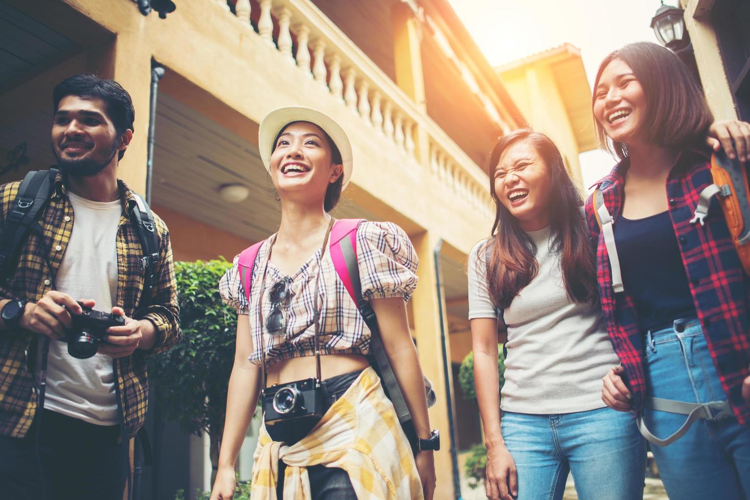 Group of happy young friends having fun walking in an urban street photo