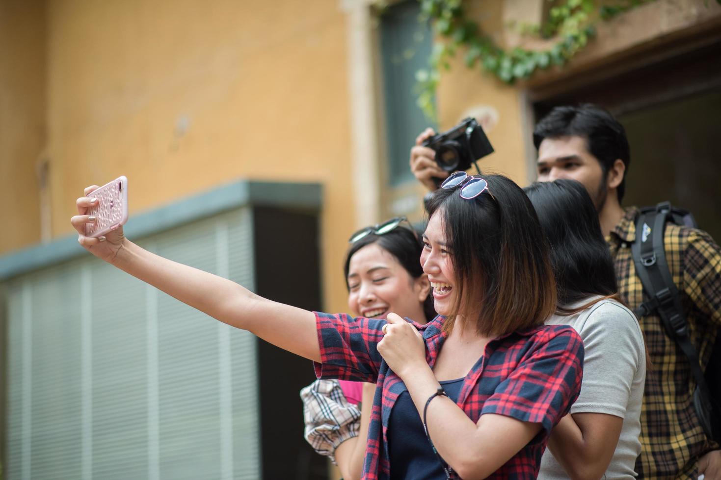 Group of friends taking a selfie in an urban street having fun together photo