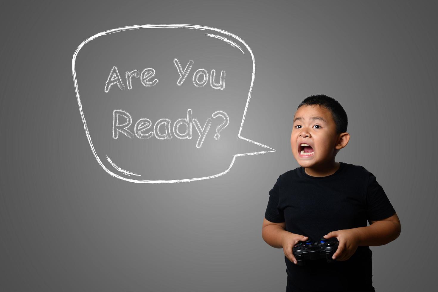 Young boy plays fun strategy games drawn on chalkboard, concept photo