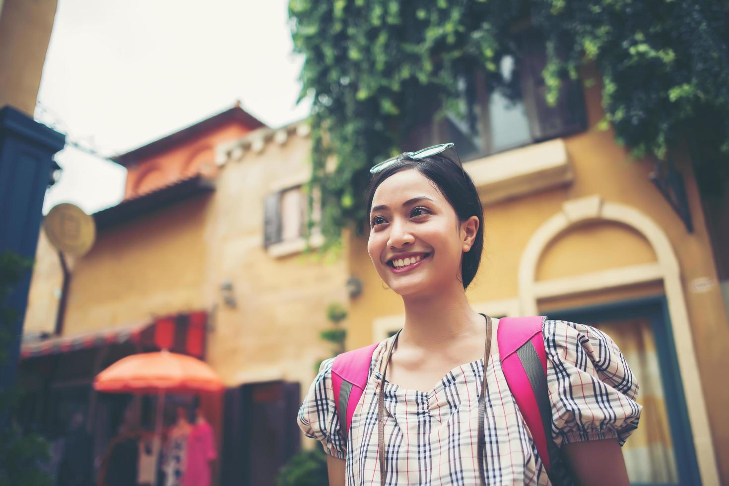 Young hipster woman taking photos in an urban area