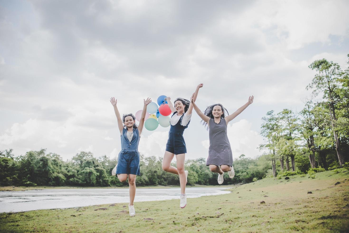 Happy teenage friends smiling outdoors at a park photo