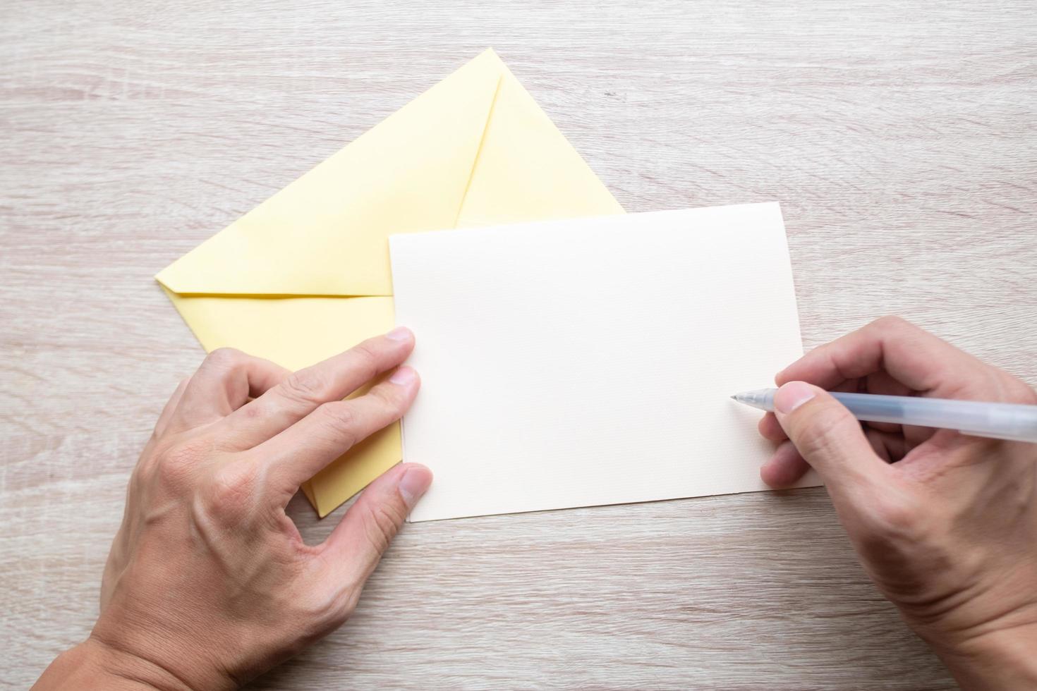 Male hands writing on a blank white card photo