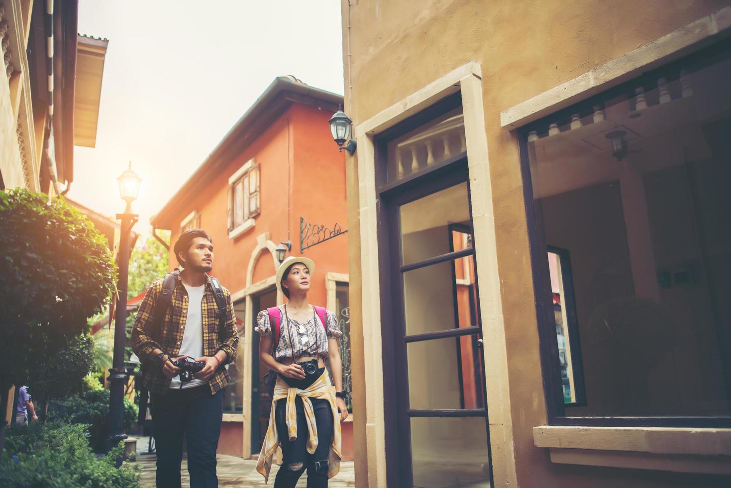 Couple of young tourists walking in the city enjoying holiday together photo