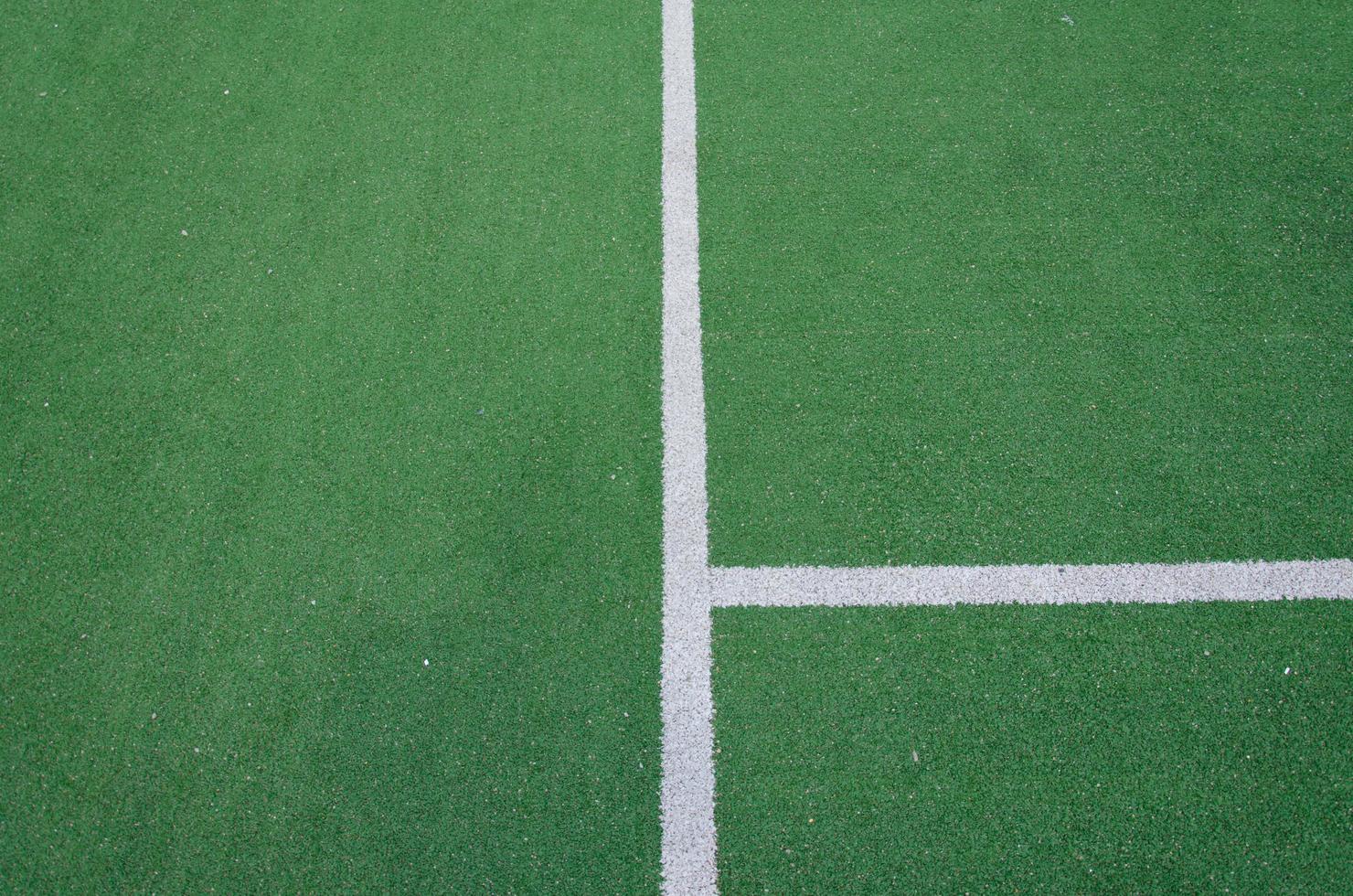 White boundary lines on a green field photo