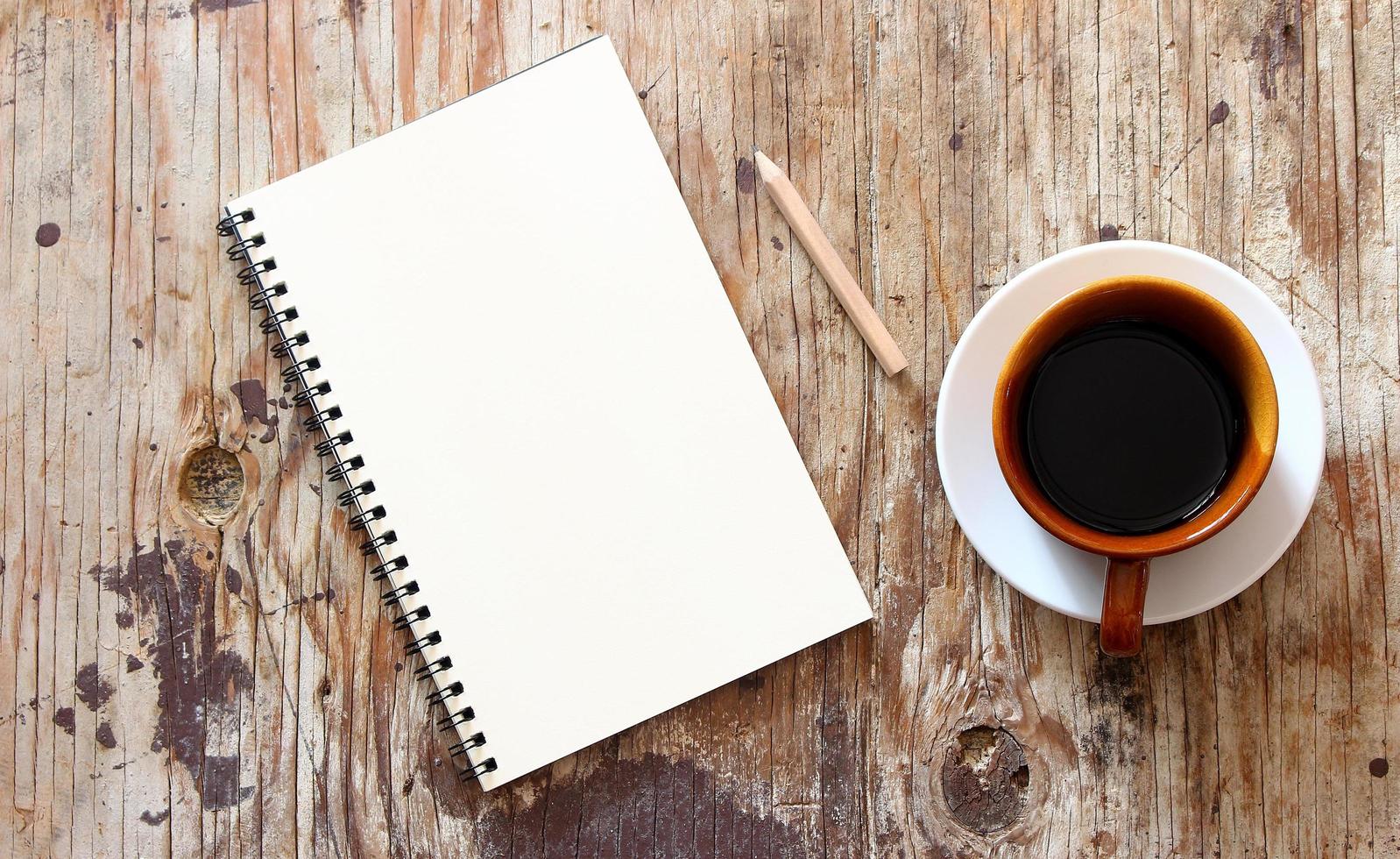 Brown coffee mug and notebook photo