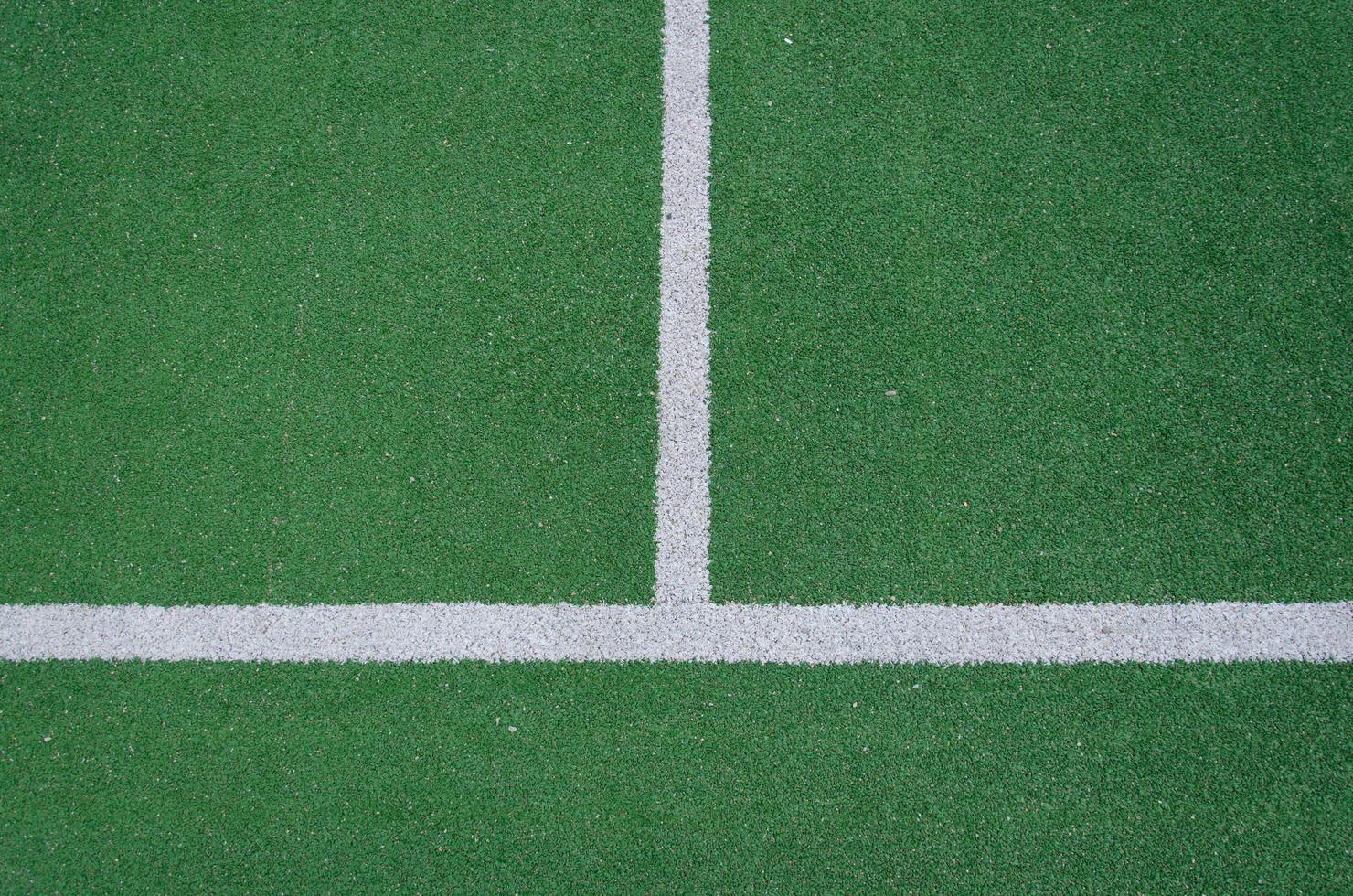 White boundary lines on a green field photo