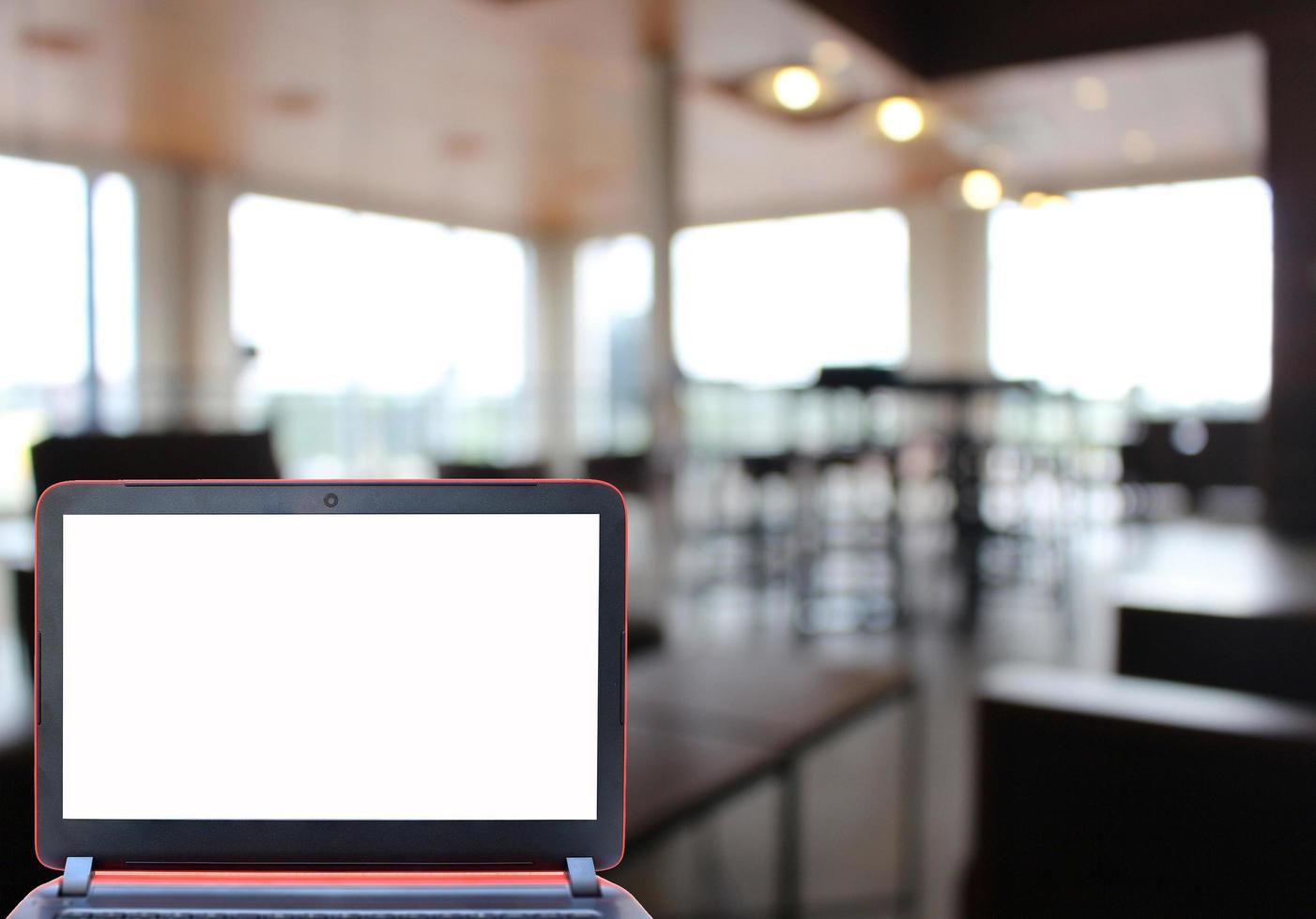 Blank laptop screen in restaurant photo