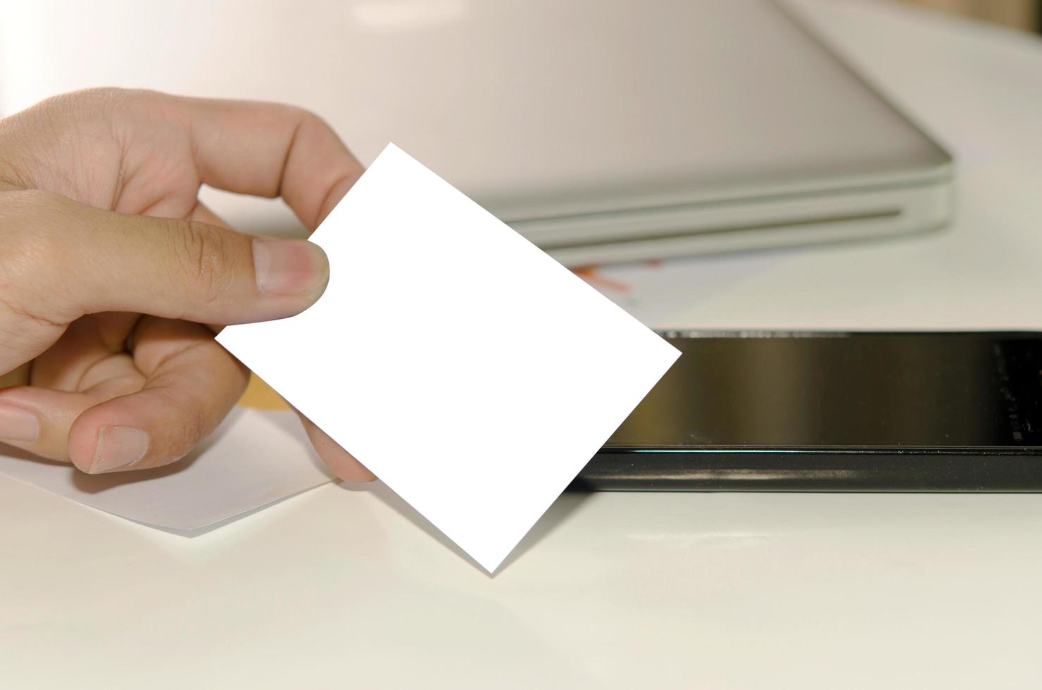 Hand holding white mock up business card photo