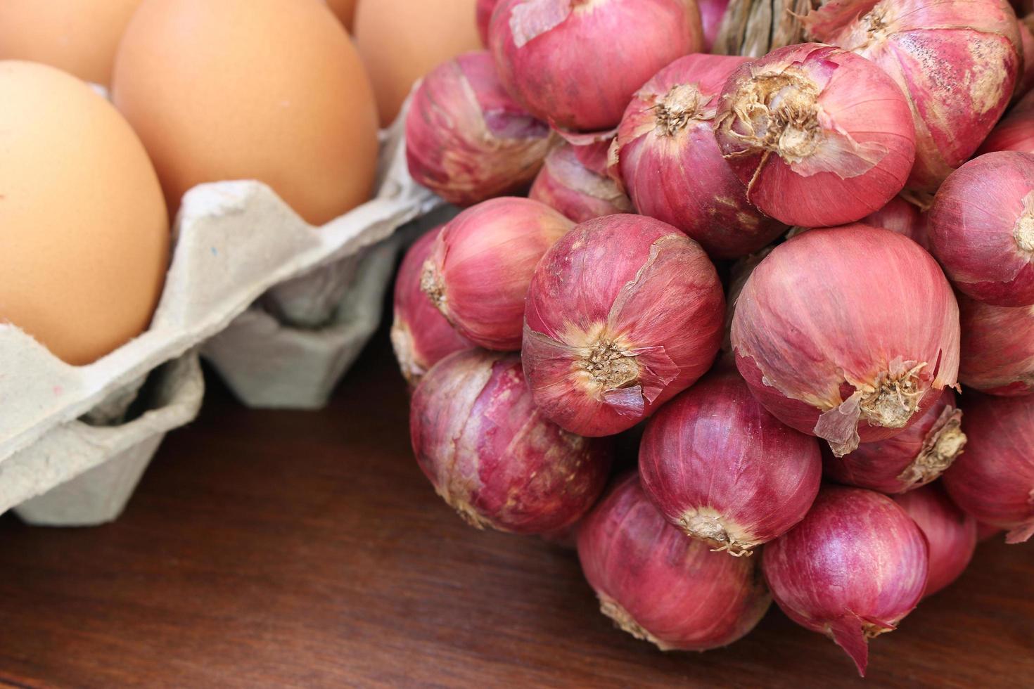 Shallots and brown eggs photo