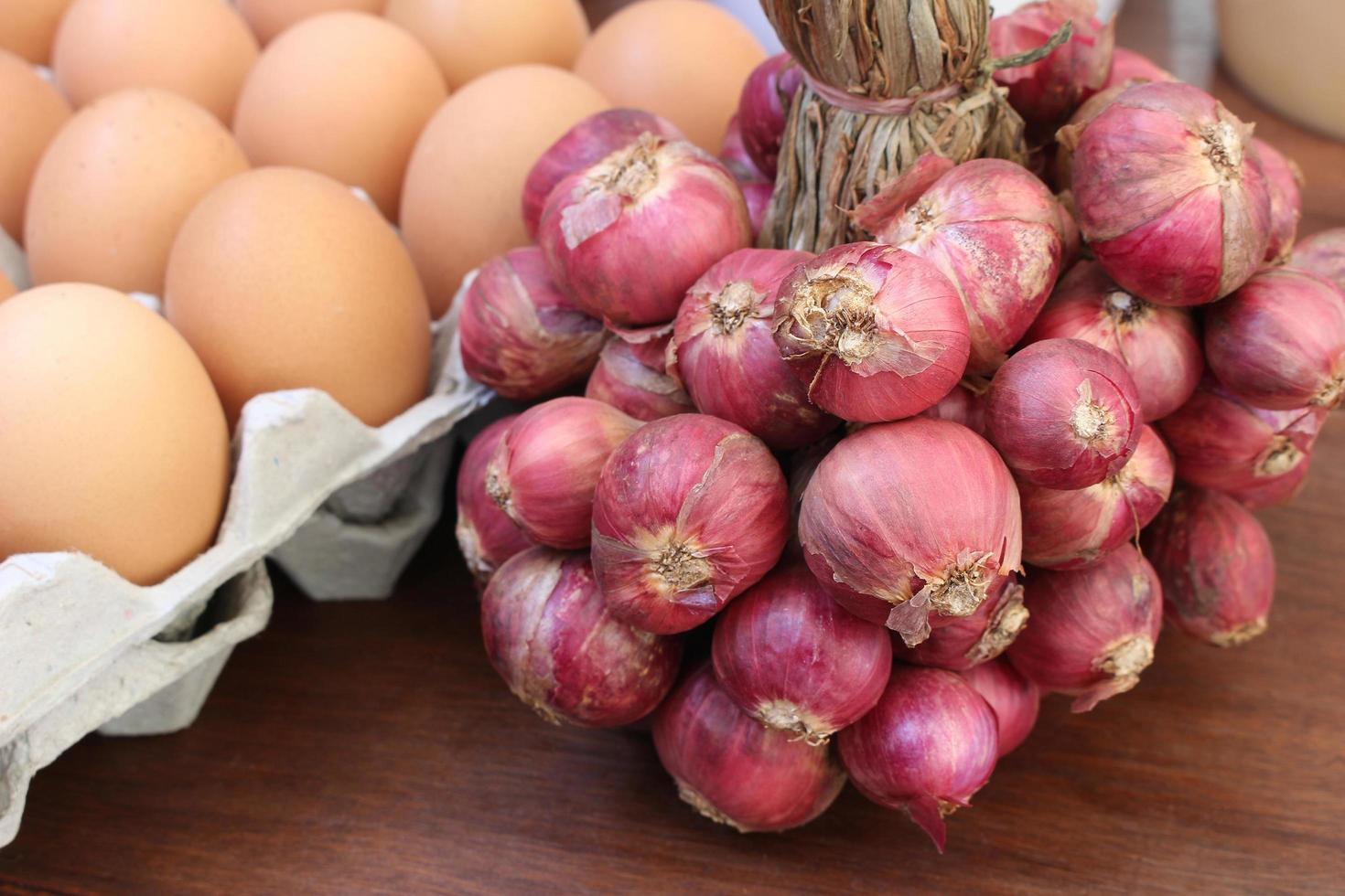 Bunch of shallots and eggs photo