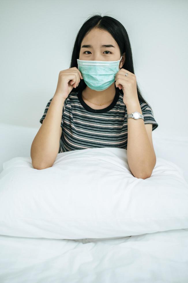 A woman wearing a striped shirt and a protective mask photo