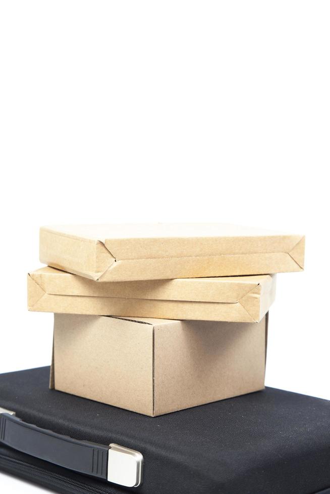 Brown paper boxes on a black briefcase photo