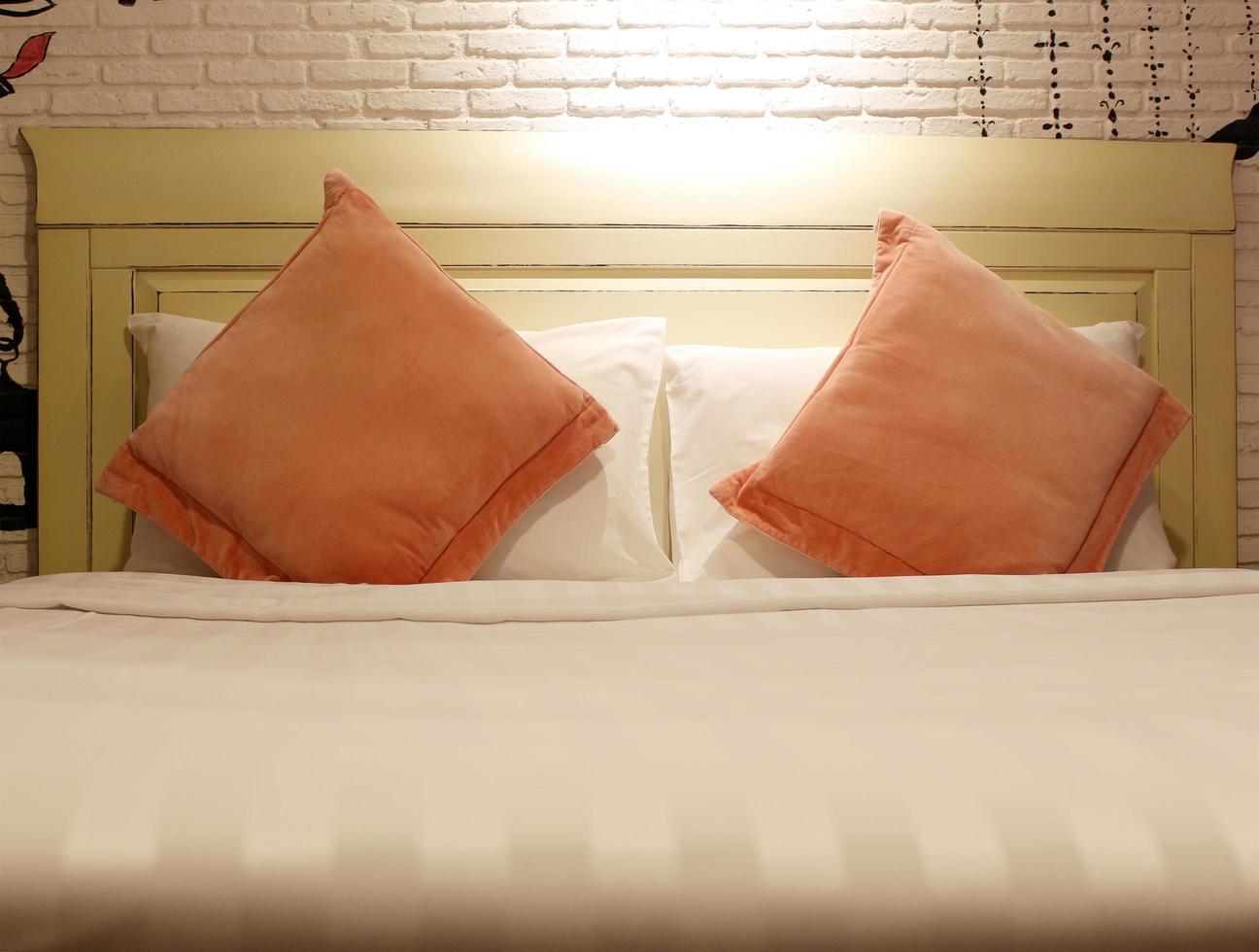Orange pillows on bed photo