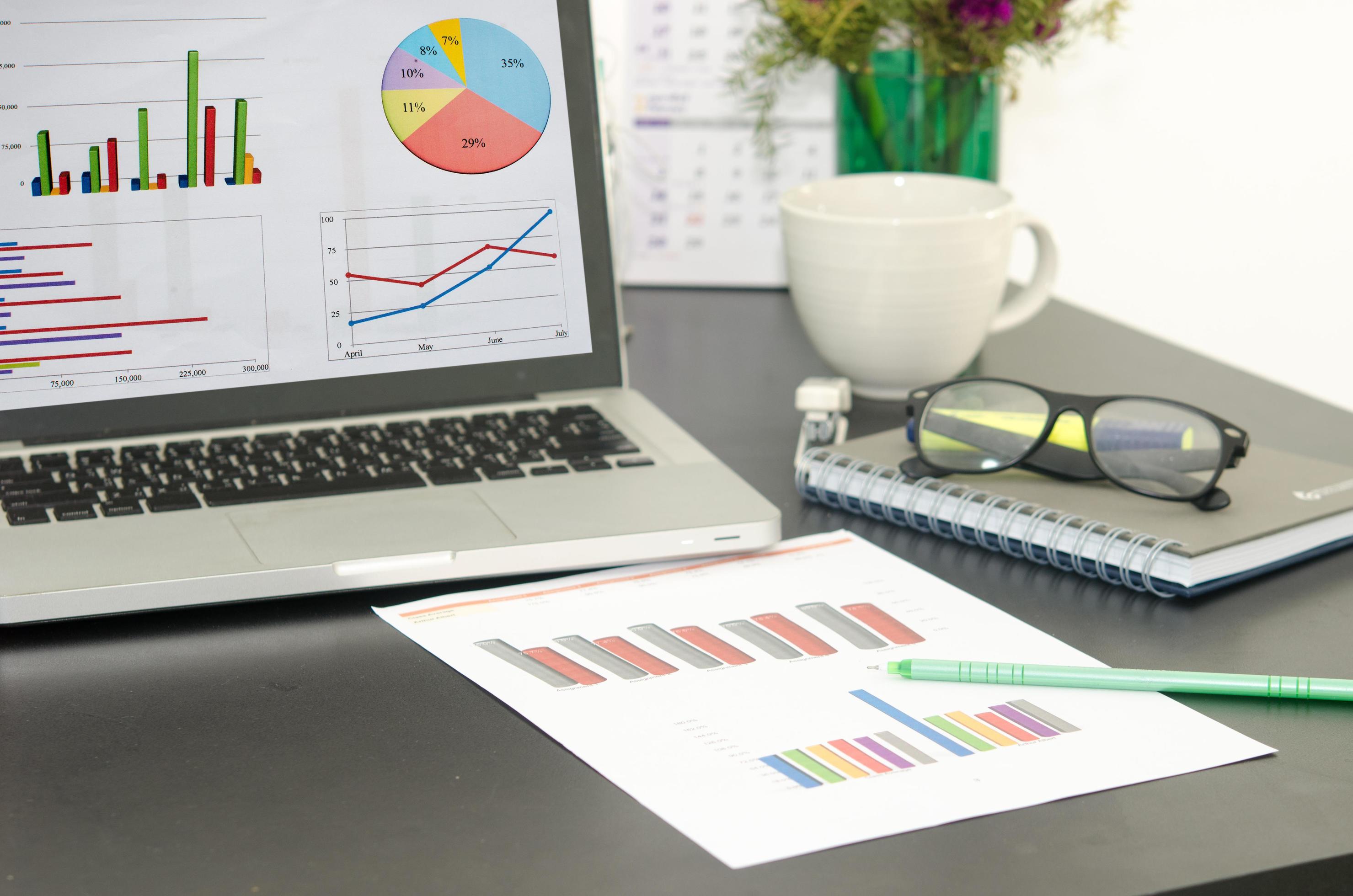 Computer and graph on desktop 1928018 Stock Photo at Vecteezy