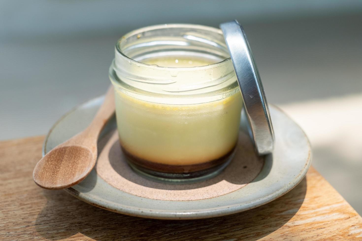 Homemade caramel custard pudding in a glass bottle photo