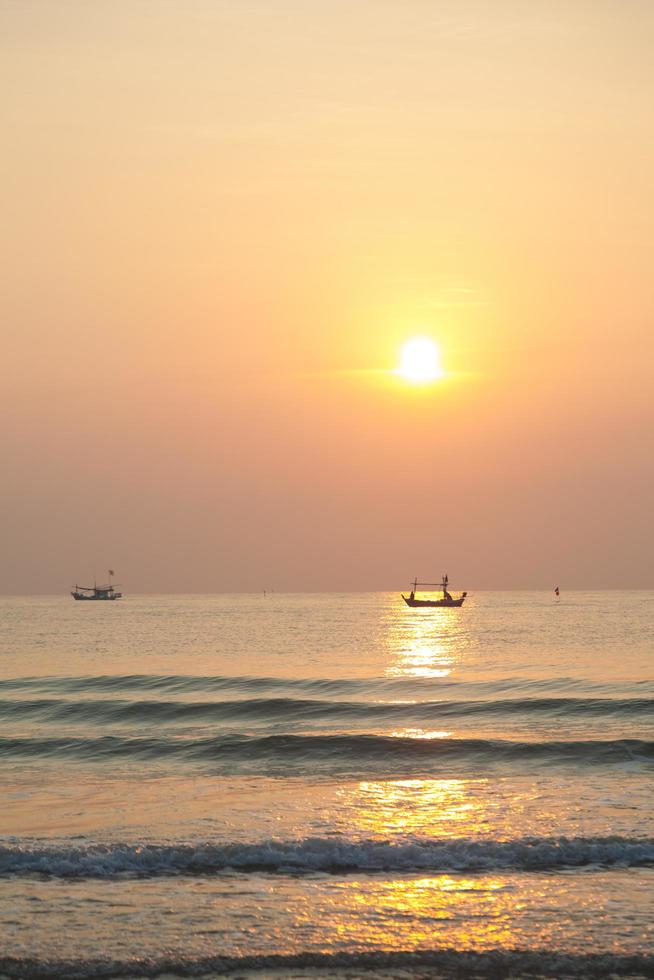 Fishing boat on the sea at sunrise photo