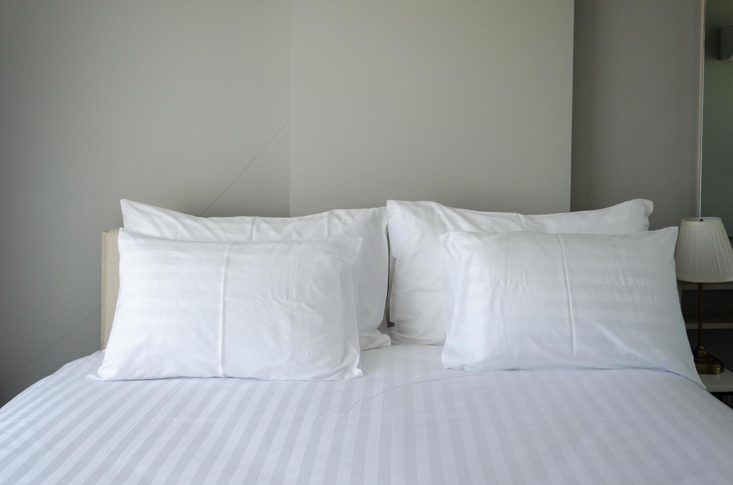 White pillows on hotel bed photo