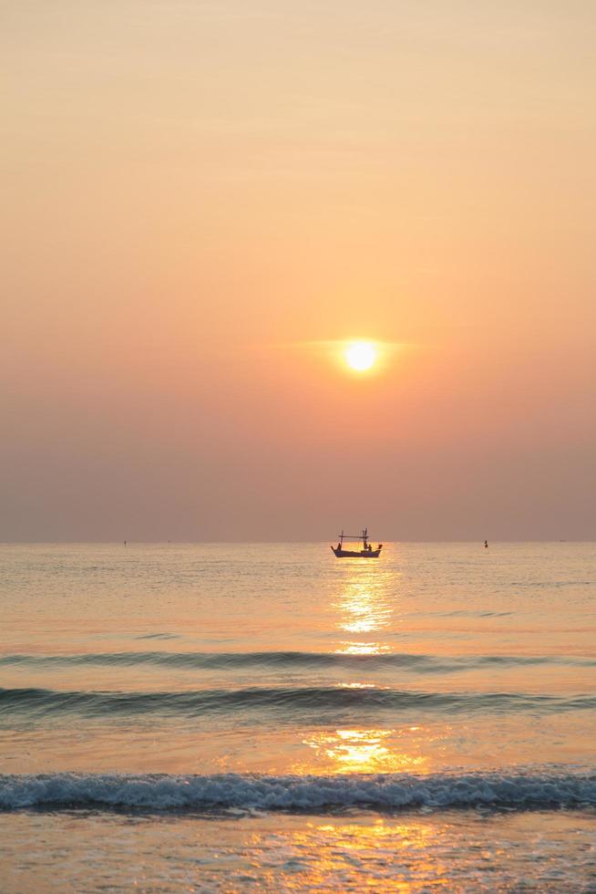 Fishing boat on the sea at sunrise photo