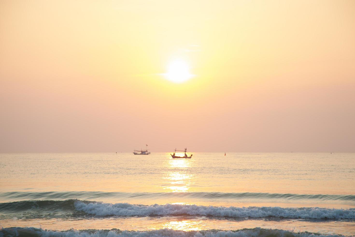 Fishing boat on the sea at sunrise photo