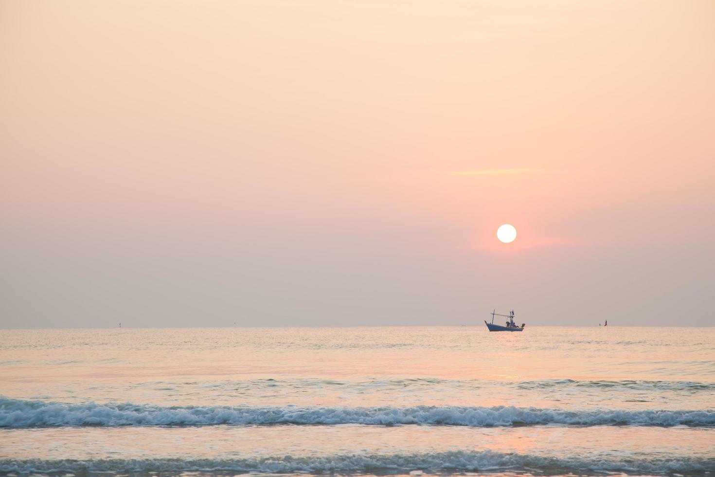 Fishing boat on the sea at sunrise photo