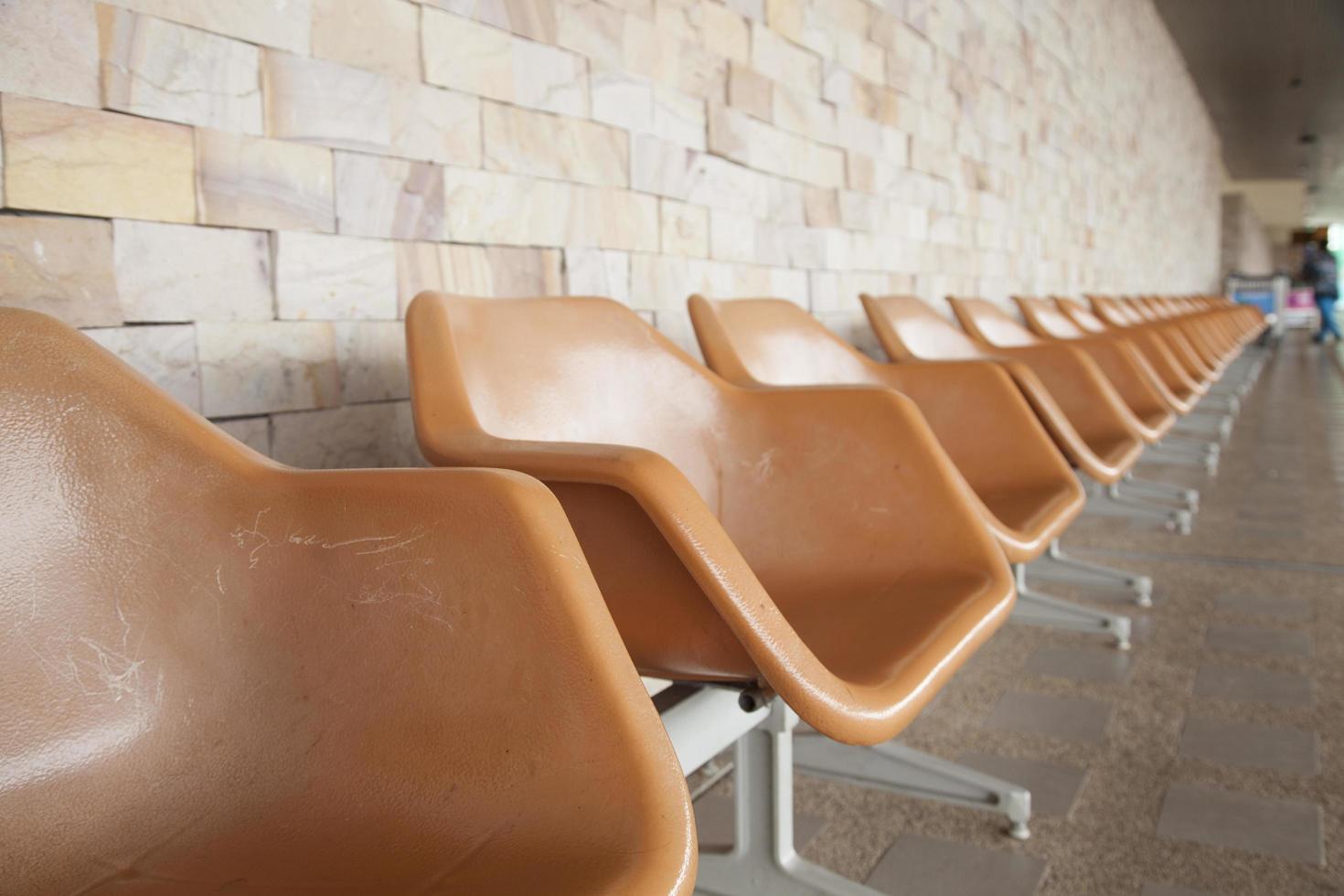 Brown plastic chairs on public area photo