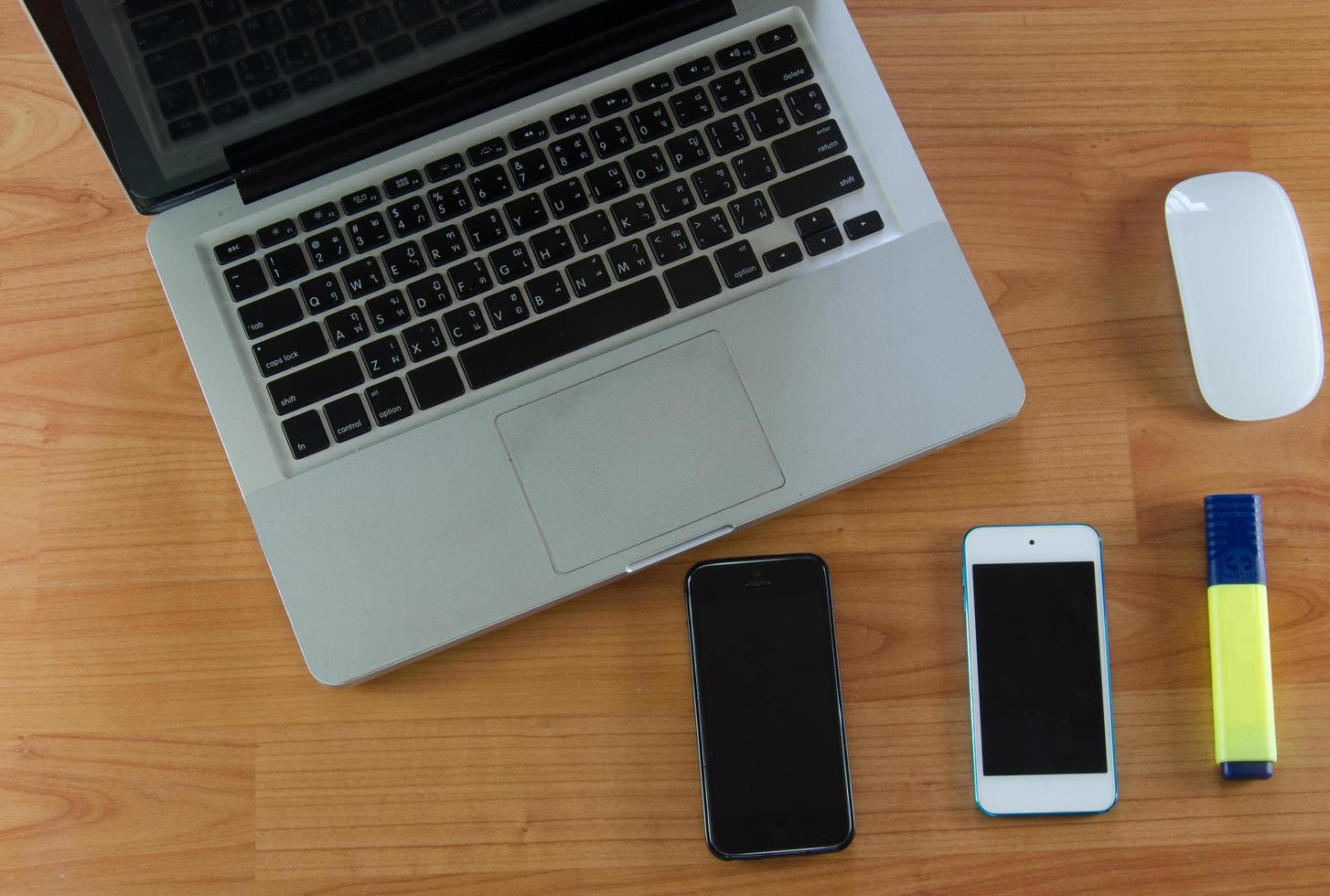Laptop and smart phones on desk photo