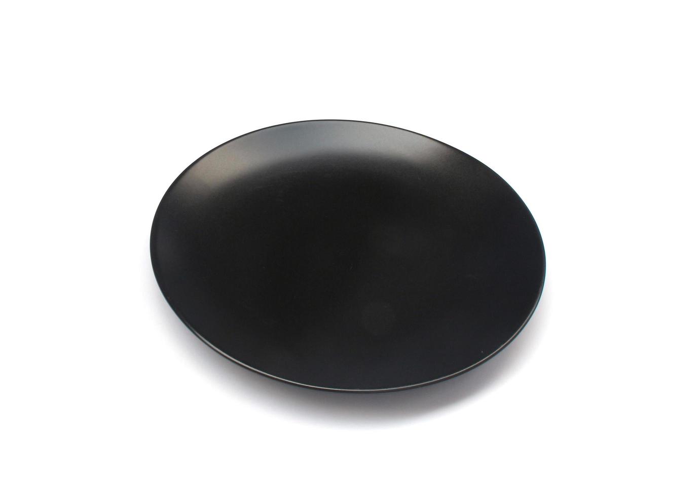 Black plate on white background photo