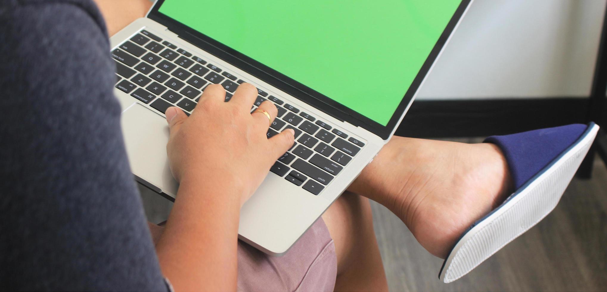 Person typing on laptop mock-up photo