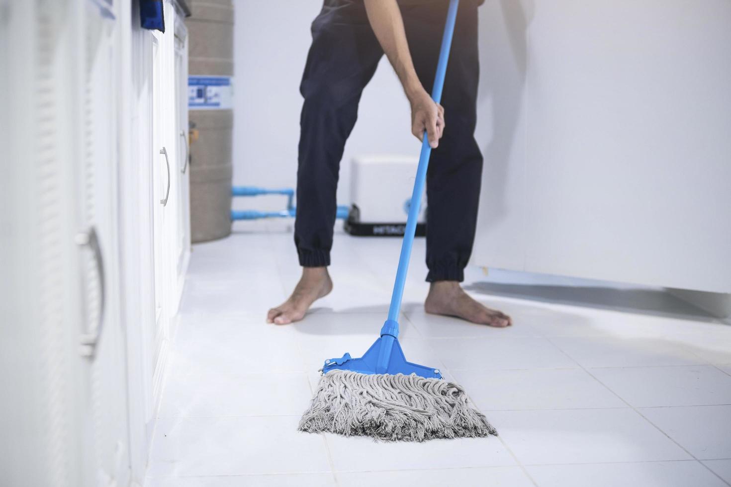 Person mopping the floor photo