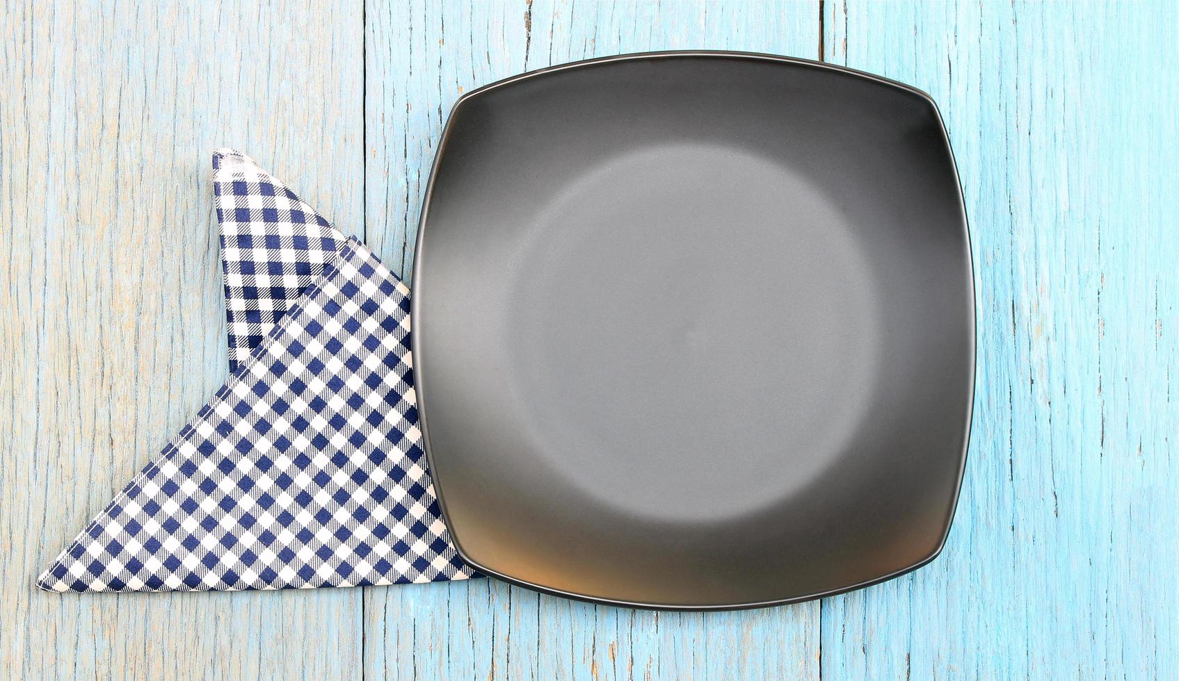 Black plate with blue and white cloth photo