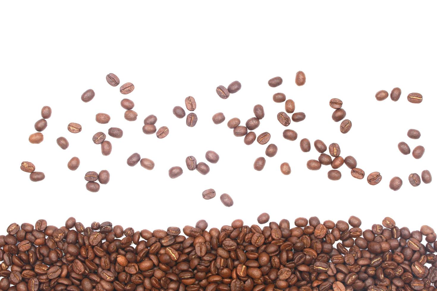 Scattered and piled coffee beans photo