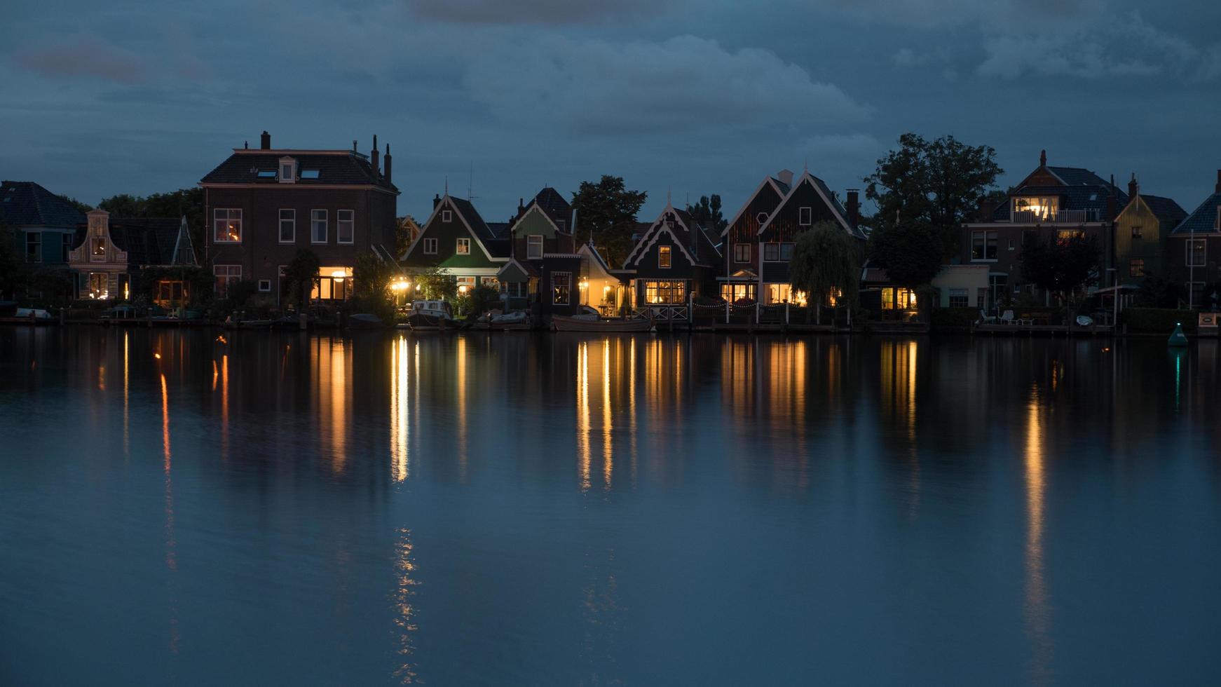 Amsterdam, Netherlands, 2020 -  Reflection of lights on a riverbank photo