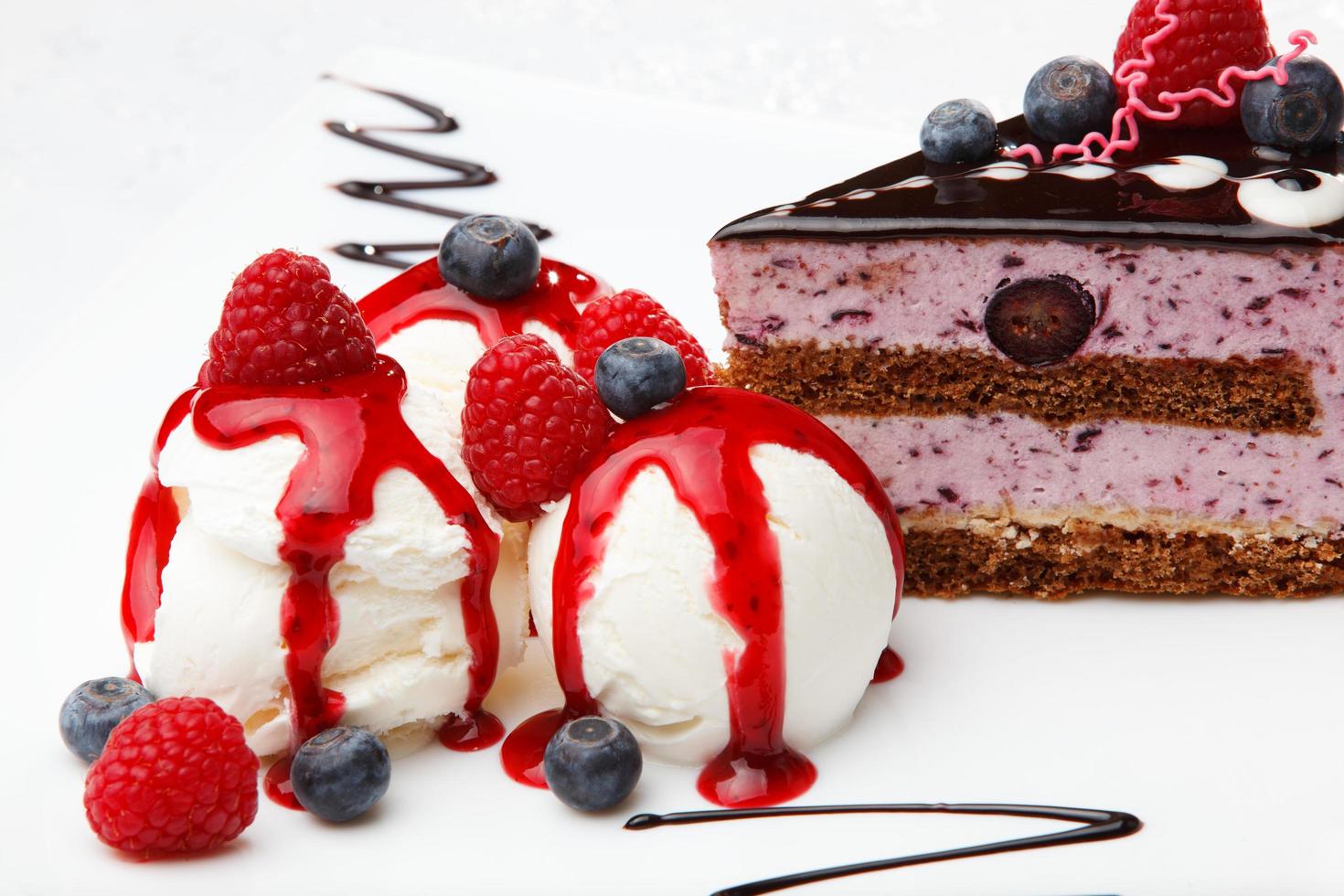 Vanilla ice cream with berry coulis and fresh fruit photo