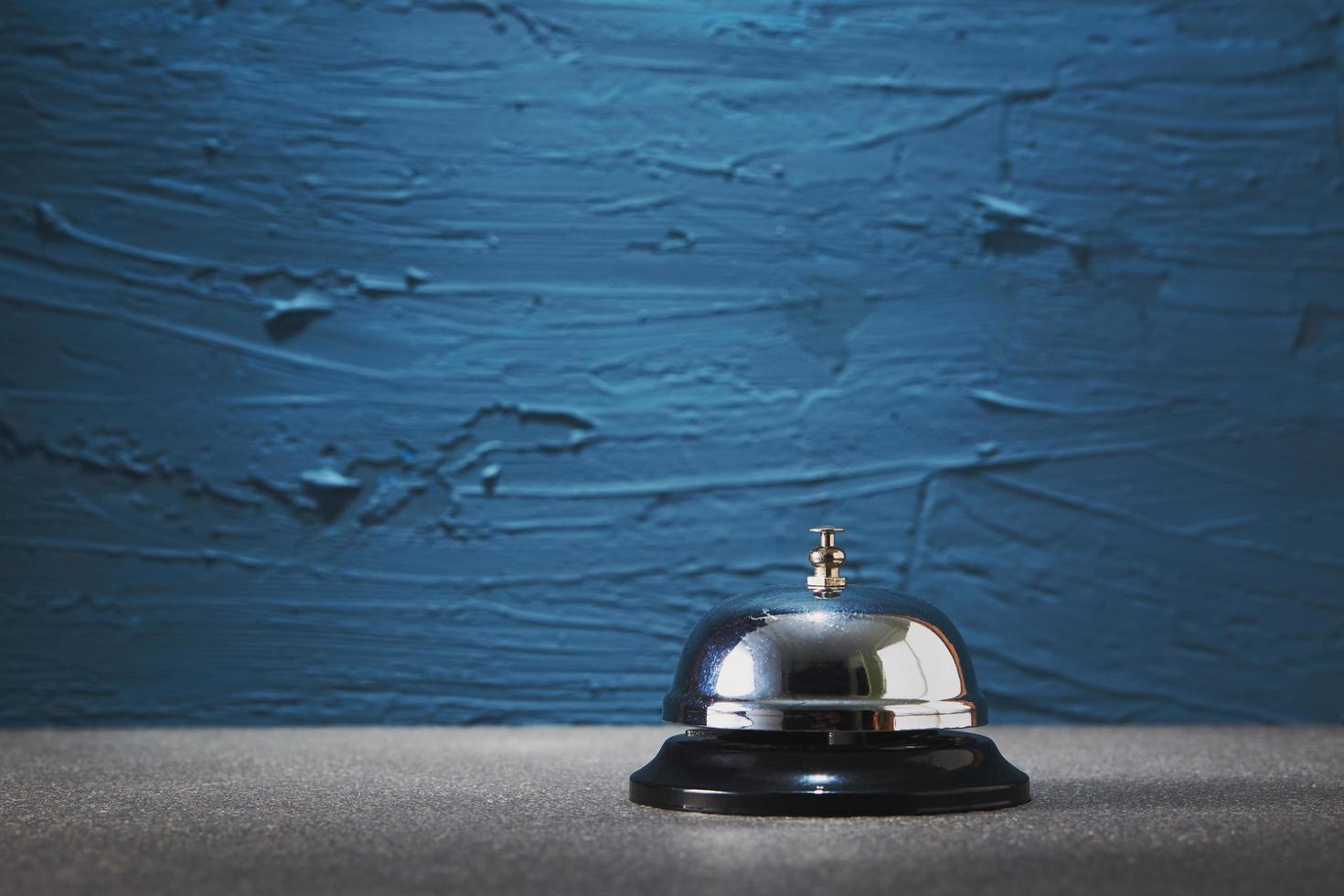 Service bell against a painted blue background photo