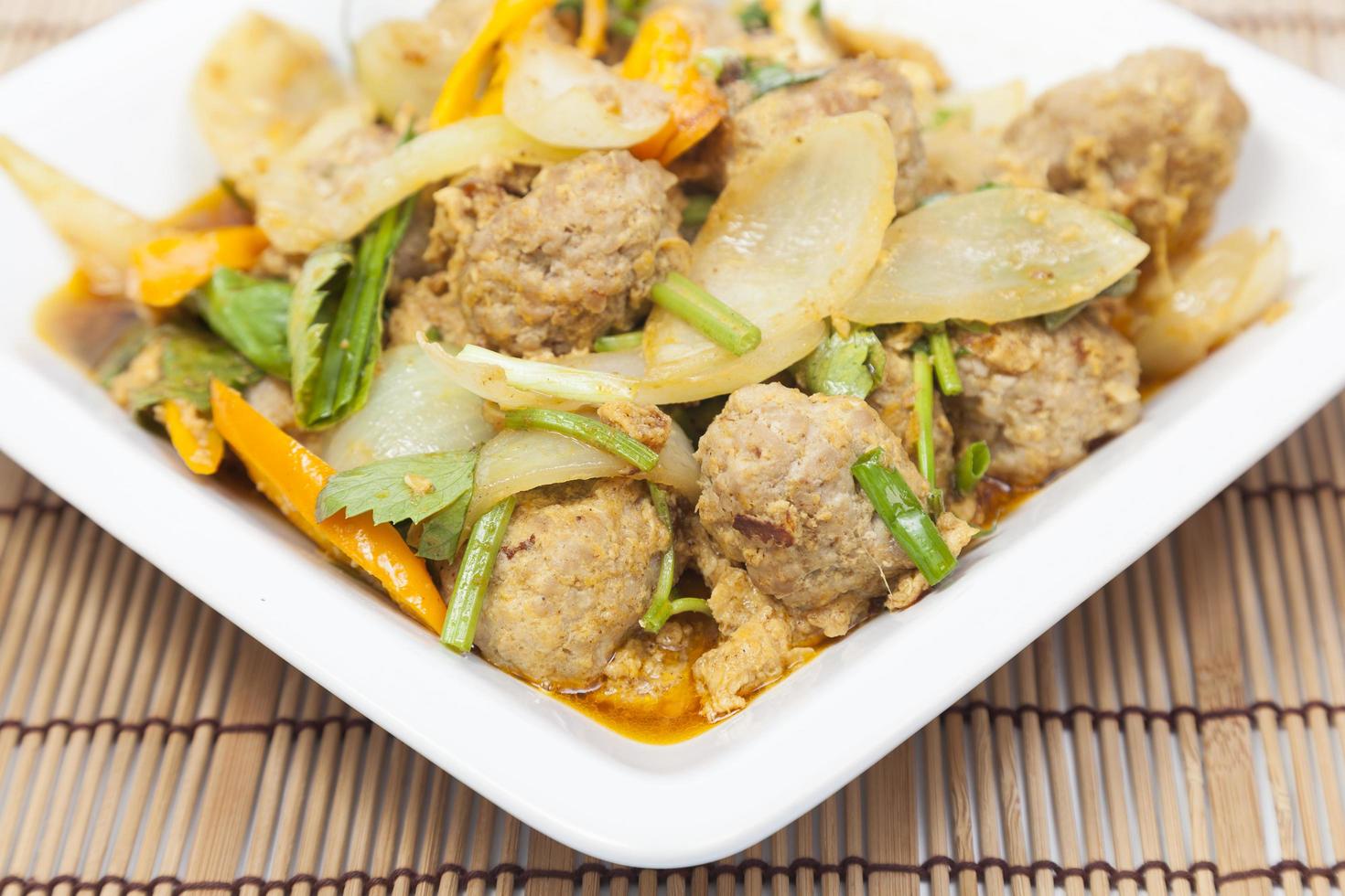 Fried pork curry on white plate photo