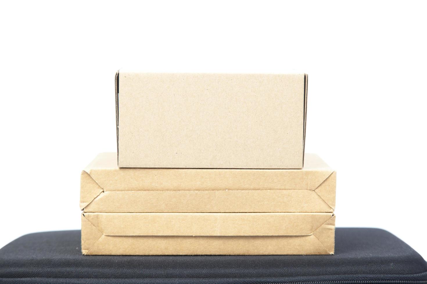 Brown paper boxes on a black briefcase photo