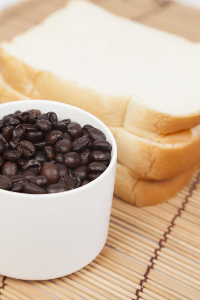 Bread and cup with coffee beans photo