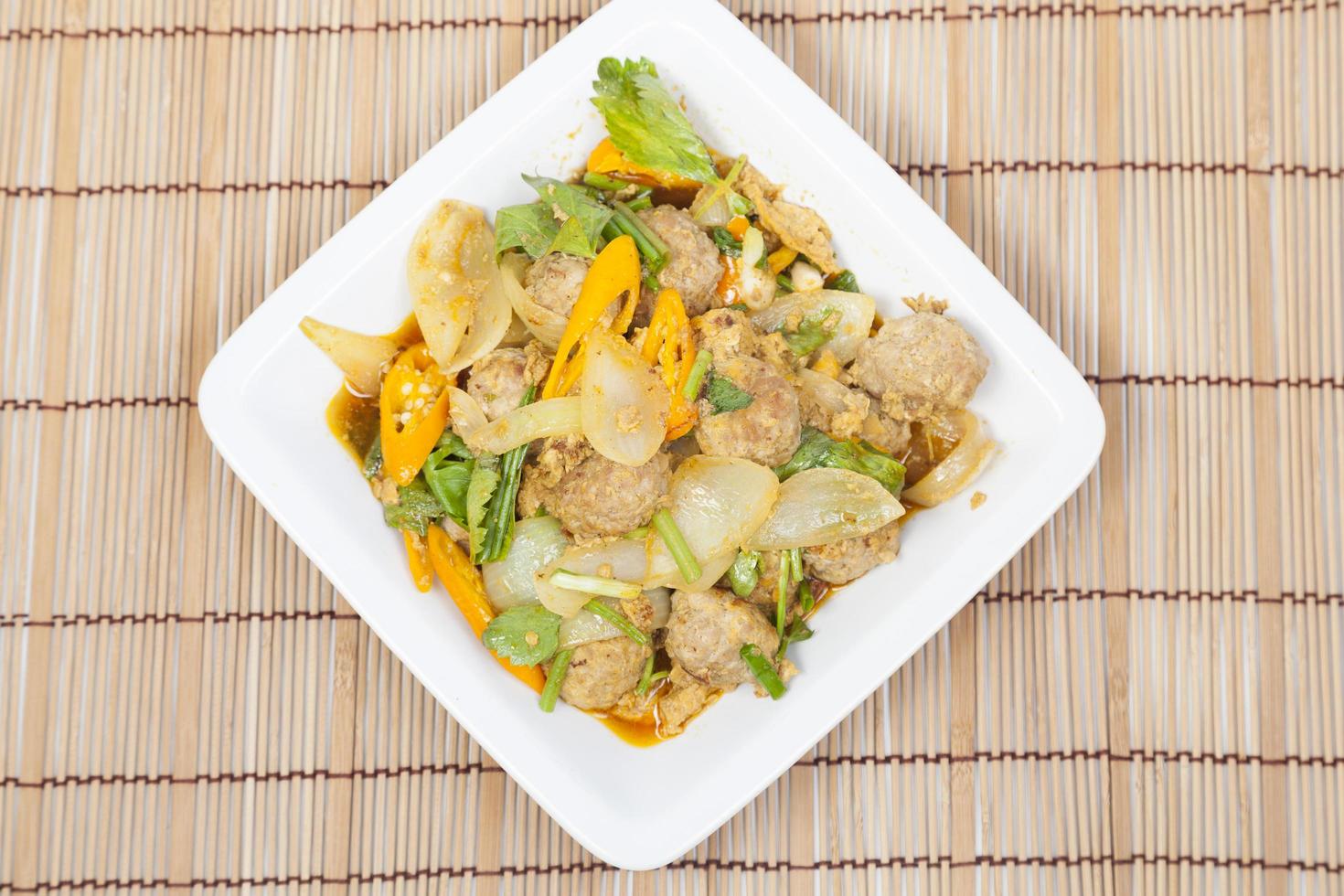 Fried pork curry on white plate photo