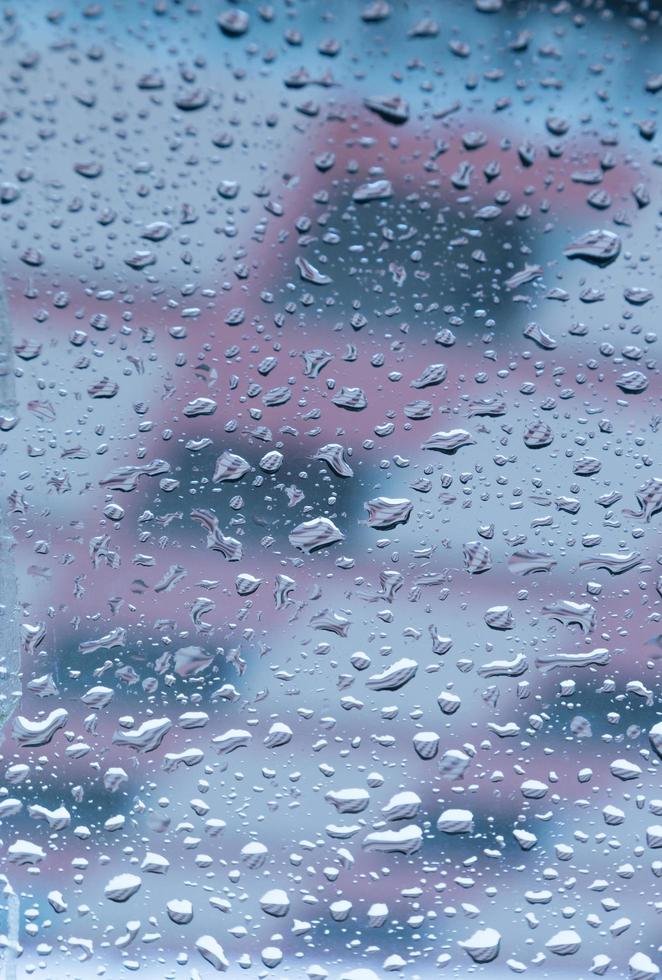 Drops of water perched on the glass photo