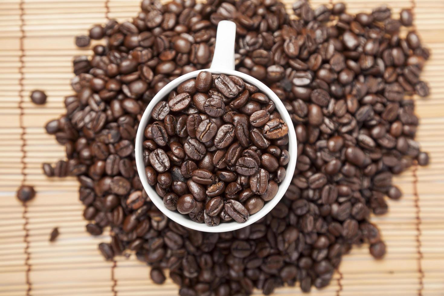 Coffee beans in a coffee cup photo